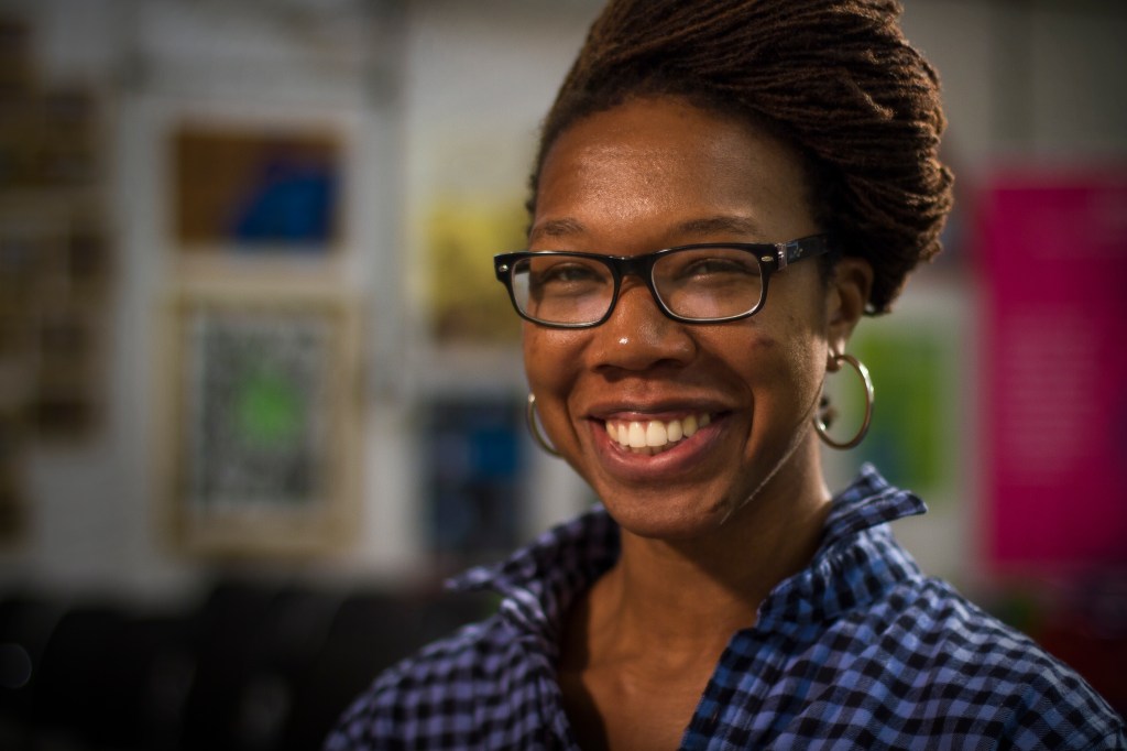 Woman in check shirt and glasses